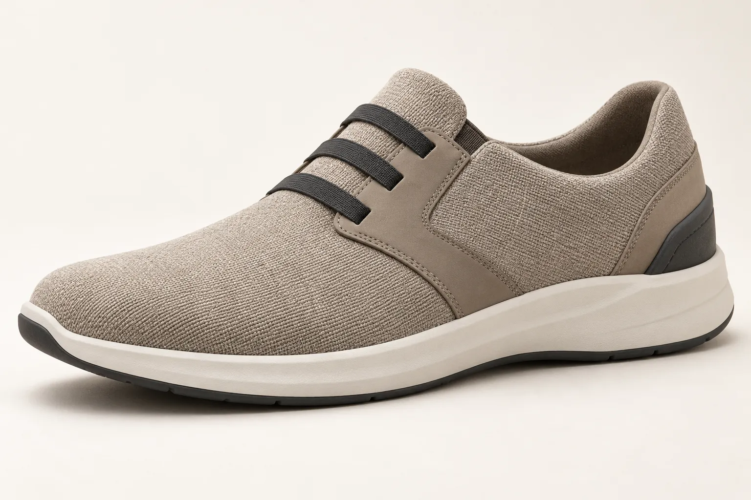 Three-quarter view of an unbranded men's easy-on lifestyle sneaker concept in warm taupe, beige and charcoal.