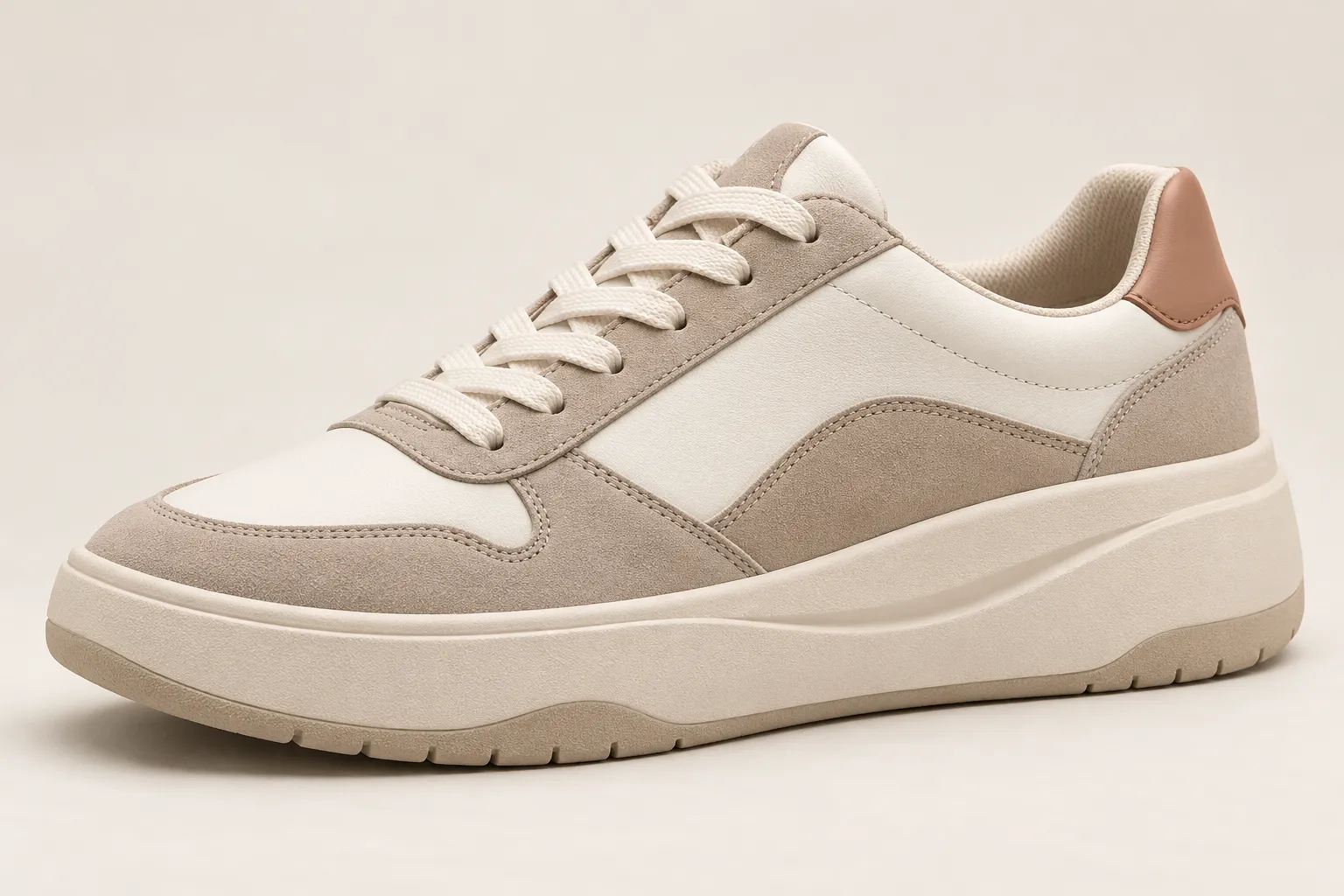 Three-quarter view of an unbranded women's platform lifestyle sneaker concept in cream, taupe and soft rose.