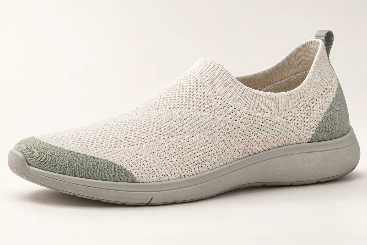 Three-quarter view of an unbranded women's knit-look slip-on concept in warm ivory, sage and light gray.