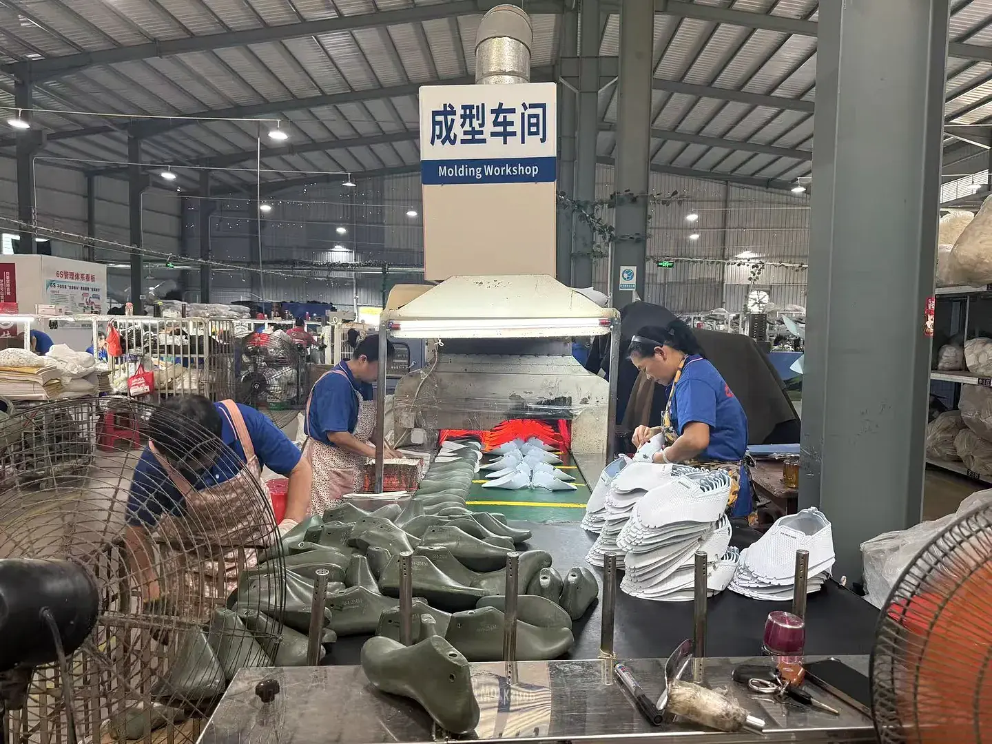 Wide view of employees and production equipment inside the GRAND STAR footwear factory